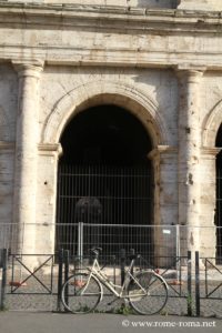 An arch with a door from the Colosseum to Rome
