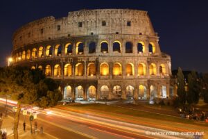 View of the outside of the Coliseum by night in Rome