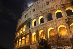 View of the outside of the Coliseum by night in Rome